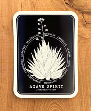 Load image into Gallery viewer, Agave Spirit Sticker 2.55&quot; wide by 3.5&quot; in height displayed on wood for contrast. Design is white on a black background with rounded corners.  Each vinyl sticker has an easy peel backing with a standard gloss finish.
