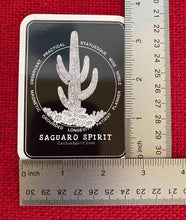 Load image into Gallery viewer, The Saguaro Spirit Sticker is measured here by two (2) rulers. The size is 2.55&quot; wide by 3.5&quot; high.
