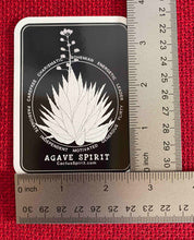 Load image into Gallery viewer, The Agave Spirit Sticker is measured here by two (2) rulers. The size is 2.55&quot; wide by 3.5&quot; high.
