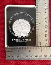 Load image into Gallery viewer, The Barrel Spirit Sticker is measured here by two (2) rulers. The size is 2.55&quot; wide by 3.5&quot; high.
