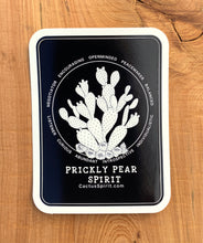 Load image into Gallery viewer, Prickly Pear Spirit Sticker 2.55&quot; wide by 3.5&quot; in height displayed on wood for contrast. Design is white on a black background with rounded corners.  Each vinyl sticker has an easy peel backing with a standard gloss finish. 
